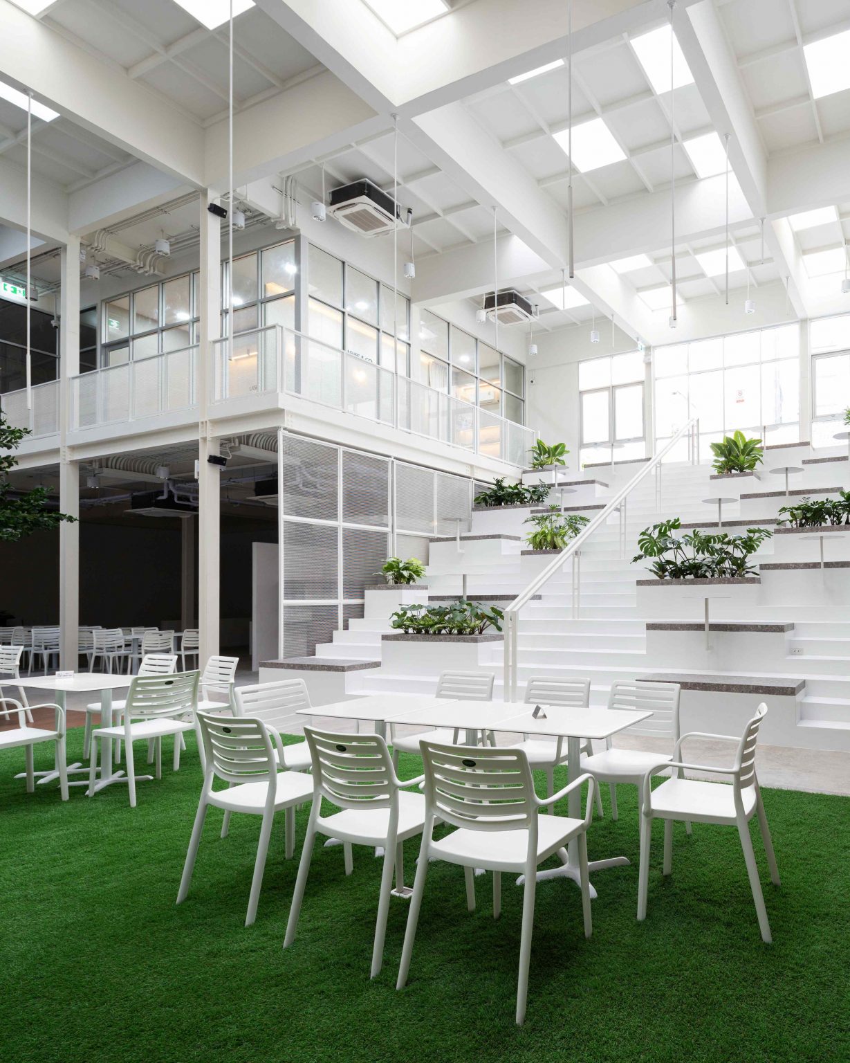 White Cloud Community Space – Community ฟีลบ้านเพื่อน ในพื้นที่บ้านเก่าอนุรักษ์และโครงสร้างใหม่จากเหล็ก SYS White Cloud Community Space เป็นการออกแบบพื้นที่ให้เช่าและ Community Space บนพื้นที่ย่านอารีย์ที่แต่เดิมมีบ้านหลังเก่าตั้งอยู่ โดยโจทย์ตั้งต้นคือการคงบ้านหลังเดิมที่มีความทรงจำและความสำคัญต่อเจ้าของที่ดินเอาไว้ สถาปนิกจึงทำการออกแบบพื้นที่ใช้งานใหม่โอบล้อมบ้านหลังเก่า เปลี่ยนบ้านเป็นไฮไลท์ และสร้างพื้นที่ใช้งานในร่มโอบล้อมโดยรอบ เพื่อให้ผู้คนเข้ามาใช้งานได้อย่างสะดวกสบายตลอดทั้งวัน ในพื้นที่อาคารประมาณ 1,200 ตารางเมตร (ไม่รวมพื้นที่จอดรถ) โครงการนี้ออกแบบโดย คุณอภิชัย จารุรัตนเกื้อ หรือคุณปริ้นท์ Architect Designer จาก Design to the Universe Co., Ltd. (บริษัท ดีไซน์ ทู เดอะ ยูนิเวิร์ส จำกัด) ผู้มีประสบการณ์ในการออกแบบงาน Commercial, Hospitality & Education Building ในหลากหลายโครงการ เช่น Holiday Pastry หน้าร้านชงดีที่ One Bangkok และ Central World หรือโรงพยาบาลหลายแห่ง เป็นผู้นำในการออกแบบ แบ่งสัดส่วนพื้นที่อย่างเป็นระบบ และสร้างเอกลักษณ์ให้กับแบรนด์ได้อย่างโดดเด่น ในโครงการ White Cloud Community Space ด้วยความต้องการให้ Space โปร่งโล่ง มีกรอบเวลาที่ชัดเจน และง่ายต่อการรื้อถอนหลังหมดสัญญาเช่า ทางสถาปนิกจึงเลือกใช้เหล็กโครงสร้าง H-BEAM จาก SYS เป็นโครงสร้างหลักของโครงการ เพราะมีคุณสมบัติที่ตอบโจทย์ทั้งงานดีไซน์ ความแข็งแรง และจัดการก่อสร้างได้สะดวก ส่งผลให้โครงการนี้เสร็จสิ้นได้รวดเร็ว มีดีไซน์ที่โปร่งโล่ง ไม่มีเสาโผล่กลางพื้นที่และตอบโจทย์เรื่องการรักษ์โลกได้จริง เป็น Community Space ยุคใหม่ ที่คุ้มค่าต่อเจ้าของโครงการในระยะยาว อีกทั้งยังสร้างความประทับใจ ความทรงจำ และประสบการณ์การใช้งานที่อบอุ่นและพิเศษให้กับผู้คนได้ทุกครั้งที่เข้ามาใช้งาน จากบ้านเก่าย่านอารีย์สู่ Community แห่งใหม่ในคอนเซ็ปต์ไข่แดง โครงการ White Cloud Community Space เริ่มต้นมาจากเจ้าของโครงการที่ต้องการเปลี่ยนบ้านเช่าหลังเก่าที่มีเอกลักษณ์เฉพาะตัวในย่านอารีย์ กรุงเทพมหานคร ให้กลายเป็น Commercial Building ที่ผู้คนสามารถเข้ามาใช้งานได้อย่างอิสระ ในขณะเดียวกันก็เปิดพื้นที่เช่าให้กับร้านค้าต่าง ๆ เข้ามาประกอบกิจกรรม ออกแบบโดยคุณอภิชัย จารุรัตนเกื้อ หรือคุณปริ้นท์ Architect Designer จาก Design to the Universe Co., Ltd. (บริษัท ดีไซน์ ทู เดอะ ยูนิเวิร์ส จำกัด) เดิมพื้นที่มีบ้านเก่า 2 ชั้นตั้งอยู่ และด้วยการเป็นพื้นที่เช่า เมื่อจบสัญญาเช่าเจ้าของโครงการจำเป็นต้องคืนพื้นที่ในสภาพเดิม ดังนั้นโครงการจึงเน้นไปที่การต่อเติมและสร้างโครงสร้างใหม่เข้ามาเสริม เพื่อรักษาโครงสร้างของบ้านเดิมเอาไว้ให้มากที่สุด และถือโอกาสชูบ้านหลังนี้ให้เป็นจุดเด่นของโครงการด้วย ทำให้บรรยากาศเสมือนการมานั่งเล่นที่บ้านเพื่อน เมื่อต้องการรักษาโครงสร้างเดิมของตัวบ้านเอาไว้ สถาปนิกจึงใช้การออกแบบและวางโครงสร้างส่วนใหม่เข้าไปรอบบ้านแทน เปรียบเสมือน “ไข่แดง (ตัวบ้านเดิม)” ที่ถูกล้อมรอบด้วย “ไข่ขาว (โครงสร้างใหม่)” โดยมีการวางพื้นที่จอดรถไว้ด้านหน้า ช่วยสร้างระยะการรับรู้จากถนน ให้ผู้ใช้งานสามารถมองเห็นความสวยงามของสถาปัตยกรรมและสัมผัสได้ถึงบรรยากาศสบาย ๆ ของโครงการได้ตั้งแต่ทางเข้า ส่วนตัวบ้านเดิมจะเป็นกระบวนการแบบ “กึ่งอนุรักษ์” คือพยายามรักษาวัสดุ โครงสร้างเดิมเอาไว้ เพื่อให้ความทรงจำของบ้านเด่นชัดและสื่อสารความรู้สึกแก่ผู้เข้ามาใช้งานได้อย่างชัดเจนที่สุด นอกจากนี้ยังใช้ “สวน” เพื่อแบ่งโซนการใช้งาน คือ สวนหน้าบ้าน เพิ่มความเขียวให้โครงการดูร่มรื่น และสวนหลังบ้านที่เป็นไฮไลท์ของโครงการ ที่มีร้านค้าหลากหลาย รวมถึงที่นั่ง บริเวณนี้จึงเกิดกิจกรรมและการเคลื่อนไหวค่อนข้างมาก เสริมให้โครงการมีชีวิตชีวามากขึ้น โครงการสีขาว เบาสบาย กับโจทย์ตั้งต้นที่โครงสร้างเหล็กกลายมาเป็นคำตอบ จากโจทย์หลักที่เป็นพื้นที่เช่า “โครงสร้างเหล็ก” จึงกลายเป็นคำตอบที่ชัดเจนสำหรับการออกแบบ เพราะโครงสร้างเหล็กสามารถต่อเติมได้สะดวกและรวดเร็วในพื้นที่ทุกขนาด เช่นเดียวกับโครงการนี้ที่ถนนหน้าโครงการค่อนข้างแคบ การเลือกความยาวเหล็กสำเร็จมาจากโรงงานทำให้การขนส่งเข้ามายังหน้างานเป็นไปอย่างราบรื่น อีกทั้งเหล็กยังสามารถติดตั้งได้รวดเร็ว ไม่กระทบโครงสร้างบ้านหลัก ตลอดจนไม่ก่อมลภาวะทางเสียงหรือฝุ่นให้กับบริบทข้างเคียงที่เป็นย่านที่พักอาศัย โดย White Cloud Community Space ใช้เวลาในการจัดการโครงสร้างเหล็กประมาณ 6 เดือนเท่านั้น (หากรวมระยะเวลาออกแบบจะใช้เวลา 9 เดือน) คุณปรินท์เล่าถึงความสำคัญของ “เวลา” ในโครงการประเภท Commercial Building ว่าโครงการประเภทนี้มักจะมีระยะเวลาในการเกิดชัดเจน ดังนั้นจึงเป็นเรื่องสำคัญมากในการเลือกใช้วัสดุให้เหมาะกับแบบที่คิดไว้และระยะเวลาที่มี ซึ่งเหล็ก H-BEAM จาก SYS ก็ตอบโจทย์ทั้งเรื่องระยะเวลาและรองรับรูปแบบของดีไซน์ที่ต้องการได้เป็นอย่างดี ไม่ว่าจะเป็นความโปร่ง เบา บางของโครงสร้าง เพื่อให้อาคารดูทันสมัย เท่เรียบง่าย แต่ไม่บดบังตัวตนของบ้านเดิม Span (ระยะห่างระหว่างเสา) ที่ยืดได้ยาวขึ้น เป็นอีกหนึ่งข้อดีของการเลือกใช้เหล็กเช่นกัน เมื่อเทียบกับโครงสร้างคอนกรีตที่ต้องมีการหล่อโครงสร้างเสาคาน อาจต้องมีคานทุก 4 เมตร ทำให้หนัาตัดคานอยู่ที่ประมาณ 40 – 50 เซนติเมตร (รวมความหนาคอนกรีตที่เททับด้านบนพื้น) แต่เมื่อเป็นโครงสร้างเหล็ก สามารถยืด Span ได้กว้างกว่าเดิม อีกทั้งในโครงการยังเลือกใช้โครงสร้าง Steel Truss ทำให้ยืดได้กว้างขึ้น ใช้จำนวนเสาในการรับน้ำหนักน้อยลง ส่งผลให้พื้นที่มีความโปร่งโล่งได้อย่างที่ต้องการ Highlight โถงสูงกลางบ้าน สร้างพื้นที่ให้กิจกรรมเชื่อมโยงถึงกัน สถาปนิกมองเผื่อไปยังอนาคตว่า ณ Community Space แห่งนี้อาจมีการขยายตัวของกิจกรรม เช่น การจัดคอนเสิร์ต จัดงานอีเวนต์ หรือทำการแสดงต่าง ๆ ซึ่งจะมีการรวมตัวของผู้คนจำนวนมาก ดังนั้นจึงเป็นแนวคิดที่ดีหากในโครงการมีพื้นที่โถงกลางเพื่อรองรับกิจกรรมนั้น โดยเมื่อเดินเข้ามาด้านในอาคาร จะเจอกับโถง Double Space ที่ฝ้าสูงประมาณ 7 – 8 เมตร มีพื้นที่ลานขนาดใหญ่ และมีการออกแบบเป็นอัฒจรรย์หรือ Amphitheater สีขาวขนาดใหญ่ที่สามารถใช้เป็นทั้งบันไดเชื่อมต่อไปยังชั้น 2 ของอาคารและใช้เป็นที่นั่งได้ ส่วนฝ้าเพดานออกแบบให้เป็นตารางรังผึ้ง มีการสลับกับช่องเปิดเพื่อนำแสงธรรมชาติลงมาสู่พื้นที่ผ่านหลังคาลอนคู่ใส 2 โทนสี คือ ลอนใสและลอนที่เคลือบสีเหลืองอบอุ่น ช่วยลดการเปิดไฟในตอนกลางวันและทำให้โถงสว่างเพียงพอต่อการใช้งาน อีกทั้งยังได้แสงที่นุ่มนวลและมีมิติมากขึ้น นอกจากนี้ยังมีการเติมรายละเอียดตามจุดต่าง ๆ ของอาคารเพื่อให้ภาพลักษณ์ สีสันที่ดูขาวสว่าง โปร่งโล่งนั้นเชื่อมโยงโดยทั่วกัน ผ่านดีไซน์ของขาโต๊ะที่ใช้เหล็ก H-BEAM นำมาตัดให้ได้ระยะใช้งานที่เหมาะสม หรือการเพิ่มฉากระแนงสีขาวแบ่งพื้นที่ใช้งานให้เป็นสัดส่วนแต่ยังคงเชื่อมโยงถึงกันผ่านการมองเห็น หลังคาที่ถูกยกความสูง เพิ่มความโปร่งให้ Space เหล็ก H-BEAM จาก SYS ไม่ได้ถูกใช้เป็นโครงสร้างของอาคารหลังใหม่เพียงเท่านั้น แต่ยังถูกใช้เพิ่มต่อเติมและเสริมให้บ้านเดิมมีความโปร่งโล่งแข็งแรงมากขึ้น ดีเทลหนึ่งที่น่าสนใจของโครงการ คือการใช้เหล็ก H-BEAM เข้ามายกความสูงของโครงสร้างหลังคาของบ้านเดิมขึ้น จากเดิมที่เพดานชั้นสองของบ้านค่อนข้างต่ำ เมื่อถูกรื้อฝ้าออกเพื่อโชว์ให้เห็น Slope ของโครงหลังคา ทำให้พื้นที่ภายในดูโปร่งมากขึ้น ส่วนของชั้นหนึ่งเองก็มีการยกเพดานขึ้นเช่นกัน โดยใช้โครงสร้างเหล็กต่อเข้ากับโครงสร้างคอนกรีตเดิมเพื่อพยุงโครงสร้างบ้านทั้งหมดให้มั่นคง อีกทั้งยังมีการรื้อฝ้าเพดานออกเพื่อให้พื้นที่ได้ความสูงโปร่งมากขึ้น โครงสร้างเหล็ก H-BEAM สีขาวที่ต่อเติมเข้ามามีความทันสมัยที่ตัดกับบรรยากาศบ้านโมเดิร์นที่ดูย้อนยุค ทำให้เกิด Contrast ของพื้นที่ที่น่าสนใจ เสมือนเดินเข้าสู่อาคารอนุรักษ์แบบร่วมสมัย เหล็ก = วัสดุที่ตอบโจทย์คุ้มค่าตั้งแต่วันแรกที่เลือกใช้ จนถึงวันสุดท้ายที่รื้อถอนอาคาร จากการที่ได้พูดคุยถึงขั้นตอนการคิด การออกแบบ และการก่อสร้างของโครงการ White Cloud Community Space กับคุณปรินท์ ทำให้ทราบว่า “สถาปนิก” หรือ “ผู้ออกแบบ” มีส่วนสำคัญที่ช่วยให้ความรู้ในเรื่องวัสดุที่เหมาะสมกับเจ้าของโครงการเป็นอย่างมาก เช่นเดียวกับในโครงการนี้ที่ทางคุณปรินท์ได้มีการเล่าเกี่ยวกับการเลือกใช้เหล็ก H-BEAM ที่นอกจากจะช่วยให้ภาพที่ออกแบบเป็นจริงตามที่ต้องการแล้ว ยังมีข้อดีอีกหลายอย่างในเชิงการใช้งาน เช่น ความรวดเร็ว ความเพรียวบางของโครงสร้าง เป็นโครงสร้างที่ไม่มีฝุ่น และที่สำคัญ คือในวันที่หมดสัญญาเช่า สามารถรื้อถอนได้ทันที สามารถขายหรือรีไซเคิลใช้งานต่อได้ ซึ่งทั้งหมดนี้ตอบโจทย์ความคุ้มค่าให้กับลูกค้าได้ในหลากหลายมุม ทั้งความใส่ใจของแบรนด์ที่มีต่ออาคารข้างเคียง และการคิดเผื่อด้านสิ่งแวดล้อมของโครงการซึ่งเป็นสิ่งที่ทั่วโลกต่างให้ความสำคัญอยู่ ณ เวลานี้ งานออกแบบที่สะท้อนให้เห็นความยืดหยุ่นในการใช้เหล็ก H-BEAM ในงานสถาปัตยกรรม (กึ่งอนุรักษ์ จากโครงการที่มีโครงสร้างบ้านเดิมอยู่แล้ว) และการก่อสร้าง ที่ช่วยสร้างเอกลักษณ์ให้กับโครงการ และตอบโจทย์หรือเงื่อนไขของโครงการได้อย่างตรงจุด ทั้งในเชิงความแข็งแรง ความสวยงาม และความยั่งยืน สนใจสินค้าเหล็ก H-BEAM และบริการจาก SYS สามารถติดต่อสอบถามได้ทางช่องทาง WEBSITE-SYS STEEL: https://bit.ly/3qYADQ0 YOUTUBE: http://bit.ly/3asNqnp LINE: https://bit.ly/3gEI0tz TikTok: https://bit.ly/46AnaTP White Cloud Community Space – Community ฟีลบ้านเพื่อน ในพื้นที่บ้านเก่าอนุรักษ์และโครงสร้างใหม่จากเหล็ก SYS White Cloud Community Space เป็นการออกแบบพื้นที่ให้เช่าและ Community Space บนพื้นที่ย่านอารีย์ที่แต่เดิมมีบ้านหลังเก่าตั้งอยู่ โดยโจทย์ตั้งต้นคือการคงบ้านหลังเดิมที่มีความทรงจำและความสำคัญต่อเจ้าของที่ดินเอาไว้ สถาปนิกจึงทำการออกแบบพื้นที่ใช้งานใหม่โอบล้อมบ้านหลังเก่า เปลี่ยนบ้านเป็นไฮไลท์ และสร้างพื้นที่ใช้งานในร่มโอบล้อมโดยรอบ เพื่อให้ผู้คนเข้ามาใช้งานได้อย่างสะดวกสบายตลอดทั้งวัน ในพื้นที่อาคารประมาณ 1,200 ตารางเมตร (ไม่รวมพื้นที่จอดรถ) โครงการนี้ออกแบบโดย คุณอภิชัย จารุรัตนเกื้อ หรือคุณปริ้นท์ Architect Designer จาก Design to the Universe Co., Ltd. (บริษัท ดีไซน์ ทู เดอะ ยูนิเวิร์ส จำกัด) ผู้มีประสบการณ์ในการออกแบบงาน Commercial, Hospitality & Education Building ในหลากหลายโครงการ เช่น Holiday Pastry หน้าร้านชงดีที่ One Bangkok และ Central World หรือโรงพยาบาลหลายแห่ง เป็นผู้นำในการออกแบบ แบ่งสัดส่วนพื้นที่อย่างเป็นระบบ และสร้างเอกลักษณ์ให้กับแบรนด์ได้อย่างโดดเด่น ในโครงการ White Cloud Community Space ด้วยความต้องการให้ Space โปร่งโล่ง มีกรอบเวลาที่ชัดเจน และง่ายต่อการรื้อถอนหลังหมดสัญญาเช่า ทางสถาปนิกจึงเลือกใช้เหล็กโครงสร้าง H-BEAM จาก SYS เป็นโครงสร้างหลักของโครงการ เพราะมีคุณสมบัติที่ตอบโจทย์ทั้งงานดีไซน์ ความแข็งแรง และจัดการก่อสร้างได้สะดวก ส่งผลให้โครงการนี้เสร็จสิ้นได้รวดเร็ว มีดีไซน์ที่โปร่งโล่ง ไม่มีเสาโผล่กลางพื้นที่และตอบโจทย์เรื่องการรักษ์โลกได้จริง เป็น Community Space ยุคใหม่ ที่คุ้มค่าต่อเจ้าของโครงการในระยะยาว อีกทั้งยังสร้างความประทับใจ ความทรงจำ และประสบการณ์การใช้งานที่อบอุ่นและพิเศษให้กับผู้คนได้ทุกครั้งที่เข้ามาใช้งาน จากบ้านเก่าย่านอารีย์สู่ Community แห่งใหม่ในคอนเซ็ปต์ไข่แดง โครงการ White Cloud Community Space เริ่มต้นมาจากเจ้าของโครงการที่ต้องการเปลี่ยนบ้านเช่าหลังเก่าที่มีเอกลักษณ์เฉพาะตัวในย่านอารีย์ กรุงเทพมหานคร ให้กลายเป็น Commercial Building ที่ผู้คนสามารถเข้ามาใช้งานได้อย่างอิสระ ในขณะเดียวกันก็เปิดพื้นที่เช่าให้กับร้านค้าต่าง ๆ เข้ามาประกอบกิจกรรม ออกแบบโดยคุณอภิชัย จารุรัตนเกื้อ หรือคุณปริ้นท์ Architect Designer จาก Design to the Universe Co., Ltd. (บริษัท ดีไซน์ ทู เดอะ ยูนิเวิร์ส จำกัด) เดิมพื้นที่มีบ้านเก่า 2 ชั้นตั้งอยู่ และด้วยการเป็นพื้นที่เช่า เมื่อจบสัญญาเช่าเจ้าของโครงการจำเป็นต้องคืนพื้นที่ในสภาพเดิม ดังนั้นโครงการจึงเน้นไปที่การต่อเติมและสร้างโครงสร้างใหม่เข้ามาเสริม เพื่อรักษาโครงสร้างของบ้านเดิมเอาไว้ให้มากที่สุด และถือโอกาสชูบ้านหลังนี้ให้เป็นจุดเด่นของโครงการด้วย ทำให้บรรยากาศเสมือนการมานั่งเล่นที่บ้านเพื่อน เมื่อต้องการรักษาโครงสร้างเดิมของตัวบ้านเอาไว้ สถาปนิกจึงใช้การออกแบบและวางโครงสร้างส่วนใหม่เข้าไปรอบบ้านแทน เปรียบเสมือน “ไข่แดง (ตัวบ้านเดิม)” ที่ถูกล้อมรอบด้วย “ไข่ขาว (โครงสร้างใหม่)” โดยมีการวางพื้นที่จอดรถไว้ด้านหน้า ช่วยสร้างระยะการรับรู้จากถนน ให้ผู้ใช้งานสามารถมองเห็นความสวยงามของสถาปัตยกรรมและสัมผัสได้ถึงบรรยากาศสบาย ๆ ของโครงการได้ตั้งแต่ทางเข้า ส่วนตัวบ้านเดิมจะเป็นกระบวนการแบบ “กึ่งอนุรักษ์” คือพยายามรักษาวัสดุ โครงสร้างเดิมเอาไว้ เพื่อให้ความทรงจำของบ้านเด่นชัดและสื่อสารความรู้สึกแก่ผู้เข้ามาใช้งานได้อย่างชัดเจนที่สุด นอกจากนี้ยังใช้ “สวน” เพื่อแบ่งโซนการใช้งาน คือ สวนหน้าบ้าน เพิ่มความเขียวให้โครงการดูร่มรื่น และสวนหลังบ้านที่เป็นไฮไลท์ของโครงการ ที่มีร้านค้าหลากหลาย รวมถึงที่นั่ง บริเวณนี้จึงเกิดกิจกรรมและการเคลื่อนไหวค่อนข้างมาก เสริมให้โครงการมีชีวิตชีวามากขึ้น โครงการสีขาว เบาสบาย กับโจทย์ตั้งต้นที่โครงสร้างเหล็กกลายมาเป็นคำตอบ จากโจทย์หลักที่เป็นพื้นที่เช่า “โครงสร้างเหล็ก” จึงกลายเป็นคำตอบที่ชัดเจนสำหรับการออกแบบ เพราะโครงสร้างเหล็กสามารถต่อเติมได้สะดวกและรวดเร็วในพื้นที่ทุกขนาด เช่นเดียวกับโครงการนี้ที่ถนนหน้าโครงการค่อนข้างแคบ การเลือกความยาวเหล็กสำเร็จมาจากโรงงานทำให้การขนส่งเข้ามายังหน้างานเป็นไปอย่างราบรื่น อีกทั้งเหล็กยังสามารถติดตั้งได้รวดเร็ว ไม่กระทบโครงสร้างบ้านหลัก ตลอดจนไม่ก่อมลภาวะทางเสียงหรือฝุ่นให้กับบริบทข้างเคียงที่เป็นย่านที่พักอาศัย โดย White Cloud Community Space ใช้เวลาในการจัดการโครงสร้างเหล็กประมาณ 6 เดือนเท่านั้น (หากรวมระยะเวลาออกแบบจะใช้เวลา 9 เดือน) คุณปรินท์เล่าถึงความสำคัญของ “เวลา” ในโครงการประเภท Commercial Building ว่าโครงการประเภทนี้มักจะมีระยะเวลาในการเกิดชัดเจน ดังนั้นจึงเป็นเรื่องสำคัญมากในการเลือกใช้วัสดุให้เหมาะกับแบบที่คิดไว้และระยะเวลาที่มี ซึ่งเหล็ก H-BEAM จาก SYS ก็ตอบโจทย์ทั้งเรื่องระยะเวลาและรองรับรูปแบบของดีไซน์ที่ต้องการได้เป็นอย่างดี ไม่ว่าจะเป็นความโปร่ง เบา บางของโครงสร้าง เพื่อให้อาคารดูทันสมัย เท่เรียบง่าย แต่ไม่บดบังตัวตนของบ้านเดิม Span (ระยะห่างระหว่างเสา) ที่ยืดได้ยาวขึ้น เป็นอีกหนึ่งข้อดีของการเลือกใช้เหล็กเช่นกัน เมื่อเทียบกับโครงสร้างคอนกรีตที่ต้องมีการหล่อโครงสร้างเสาคาน อาจต้องมีคานทุก 4 เมตร ทำให้หนัาตัดคานอยู่ที่ประมาณ 40 – 50 เซนติเมตร (รวมความหนาคอนกรีตที่เททับด้านบนพื้น) แต่เมื่อเป็นโครงสร้างเหล็ก สามารถยืด Span ได้กว้างกว่าเดิม อีกทั้งในโครงการยังเลือกใช้โครงสร้าง Steel Truss ทำให้ยืดได้กว้างขึ้น ใช้จำนวนเสาในการรับน้ำหนักน้อยลง ส่งผลให้พื้นที่มีความโปร่งโล่งได้อย่างที่ต้องการ Highlight โถงสูงกลางบ้าน สร้างพื้นที่ให้กิจกรรมเชื่อมโยงถึงกัน สถาปนิกมองเผื่อไปยังอนาคตว่า ณ Community Space แห่งนี้อาจมีการขยายตัวของกิจกรรม เช่น การจัดคอนเสิร์ต จัดงานอีเวนต์ หรือทำการแสดงต่าง ๆ ซึ่งจะมีการรวมตัวของผู้คนจำนวนมาก ดังนั้นจึงเป็นแนวคิดที่ดีหากในโครงการมีพื้นที่โถงกลางเพื่อรองรับกิจกรรมนั้น โดยเมื่อเดินเข้ามาด้านในอาคาร จะเจอกับโถง Double Space ที่ฝ้าสูงประมาณ 7 – 8 เมตร มีพื้นที่ลานขนาดใหญ่ และมีการออกแบบเป็นอัฒจรรย์หรือ Amphitheater สีขาวขนาดใหญ่ที่สามารถใช้เป็นทั้งบันไดเชื่อมต่อไปยังชั้น 2 ของอาคารและใช้เป็นที่นั่งได้ ส่วนฝ้าเพดานออกแบบให้เป็นตารางรังผึ้ง มีการสลับกับช่องเปิดเพื่อนำแสงธรรมชาติลงมาสู่พื้นที่ผ่านหลังคาลอนคู่ใส 2 โทนสี คือ ลอนใสและลอนที่เคลือบสีเหลืองอบอุ่น ช่วยลดการเปิดไฟในตอนกลางวันและทำให้โถงสว่างเพียงพอต่อการใช้งาน อีกทั้งยังได้แสงที่นุ่มนวลและมีมิติมากขึ้น นอกจากนี้ยังมีการเติมรายละเอียดตามจุดต่าง ๆ ของอาคารเพื่อให้ภาพลักษณ์ สีสันที่ดูขาวสว่าง โปร่งโล่งนั้นเชื่อมโยงโดยทั่วกัน ผ่านดีไซน์ของขาโต๊ะที่ใช้เหล็ก H-BEAM นำมาตัดให้ได้ระยะใช้งานที่เหมาะสม หรือการเพิ่มฉากระแนงสีขาวแบ่งพื้นที่ใช้งานให้เป็นสัดส่วนแต่ยังคงเชื่อมโยงถึงกันผ่านการมองเห็น หลังคาที่ถูกยกความสูง เพิ่มความโปร่งให้ Space เหล็ก H-BEAM จาก SYS ไม่ได้ถูกใช้เป็นโครงสร้างของอาคารหลังใหม่เพียงเท่านั้น แต่ยังถูกใช้เพิ่มต่อเติมและเสริมให้บ้านเดิมมีความโปร่งโล่งแข็งแรงมากขึ้น ดีเทลหนึ่งที่น่าสนใจของโครงการ คือการใช้เหล็ก H-BEAM เข้ามายกความสูงของโครงสร้างหลังคาของบ้านเดิมขึ้น จากเดิมที่เพดานชั้นสองของบ้านค่อนข้างต่ำ เมื่อถูกรื้อฝ้าออกเพื่อโชว์ให้เห็น Slope ของโครงหลังคา ทำให้พื้นที่ภายในดูโปร่งมากขึ้น ส่วนของชั้นหนึ่งเองก็มีการยกเพดานขึ้นเช่นกัน โดยใช้โครงสร้างเหล็กต่อเข้ากับโครงสร้างคอนกรีตเดิมเพื่อพยุงโครงสร้างบ้านทั้งหมดให้มั่นคง อีกทั้งยังมีการรื้อฝ้าเพดานออกเพื่อให้พื้นที่ได้ความสูงโปร่งมากขึ้น โครงสร้างเหล็ก H-BEAM สีขาวที่ต่อเติมเข้ามามีความทันสมัยที่ตัดกับบรรยากาศบ้านโมเดิร์นที่ดูย้อนยุค ทำให้เกิด Contrast ของพื้นที่ที่น่าสนใจ เสมือนเดินเข้าสู่อาคารอนุรักษ์แบบร่วมสมัย เหล็ก = วัสดุที่ตอบโจทย์คุ้มค่าตั้งแต่วันแรกที่เลือกใช้ จนถึงวันสุดท้ายที่รื้อถอนอาคาร จากการที่ได้พูดคุยถึงขั้นตอนการคิด การออกแบบ และการก่อสร้างของโครงการ White Cloud Community Space กับคุณปรินท์ ทำให้ทราบว่า “สถาปนิก” หรือ “ผู้ออกแบบ” มีส่วนสำคัญที่ช่วยให้ความรู้ในเรื่องวัสดุที่เหมาะสมกับเจ้าของโครงการเป็นอย่างมาก เช่นเดียวกับในโครงการนี้ที่ทางคุณปรินท์ได้มีการเล่าเกี่ยวกับการเลือกใช้เหล็ก H-BEAM ที่นอกจากจะช่วยให้ภาพที่ออกแบบเป็นจริงตามที่ต้องการแล้ว ยังมีข้อดีอีกหลายอย่างในเชิงการใช้งาน เช่น ความรวดเร็ว ความเพรียวบางของโครงสร้าง เป็นโครงสร้างที่ไม่มีฝุ่น และที่สำคัญ คือในวันที่หมดสัญญาเช่า สามารถรื้อถอนได้ทันที สามารถขายหรือรีไซเคิลใช้งานต่อได้ ซึ่งทั้งหมดนี้ตอบโจทย์ความคุ้มค่าให้กับลูกค้าได้ในหลากหลายมุม ทั้งความใส่ใจของแบรนด์ที่มีต่ออาคารข้างเคียง และการคิดเผื่อด้านสิ่งแวดล้อมของโครงการซึ่งเป็นสิ่งที่ทั่วโลกต่างให้ความสำคัญอยู่ ณ เวลานี้ งานออกแบบที่สะท้อนให้เห็นความยืดหยุ่นในการใช้เหล็ก H-BEAM ในงานสถาปัตยกรรม (กึ่งอนุรักษ์ จากโครงการที่มีโครงสร้างบ้านเดิมอยู่แล้ว) และการก่อสร้าง ที่ช่วยสร้างเอกลักษณ์ให้กับโครงการ และตอบโจทย์หรือเงื่อนไขของโครงการได้อย่างตรงจุด ทั้งในเชิงความแข็งแรง ความสวยงาม และความยั่งยืน สนใจสินค้าเหล็ก H-BEAM และบริการจาก SYS สามารถติดต่อสอบถามได้ทางช่องทาง WEBSITE-SYS STEEL: https://bit.ly/3qYADQ0 YOUTUBE: http://bit.ly/3asNqnp LINE: https://bit.ly/3gEI0tz TikTok: https://bit.ly/46AnaTP